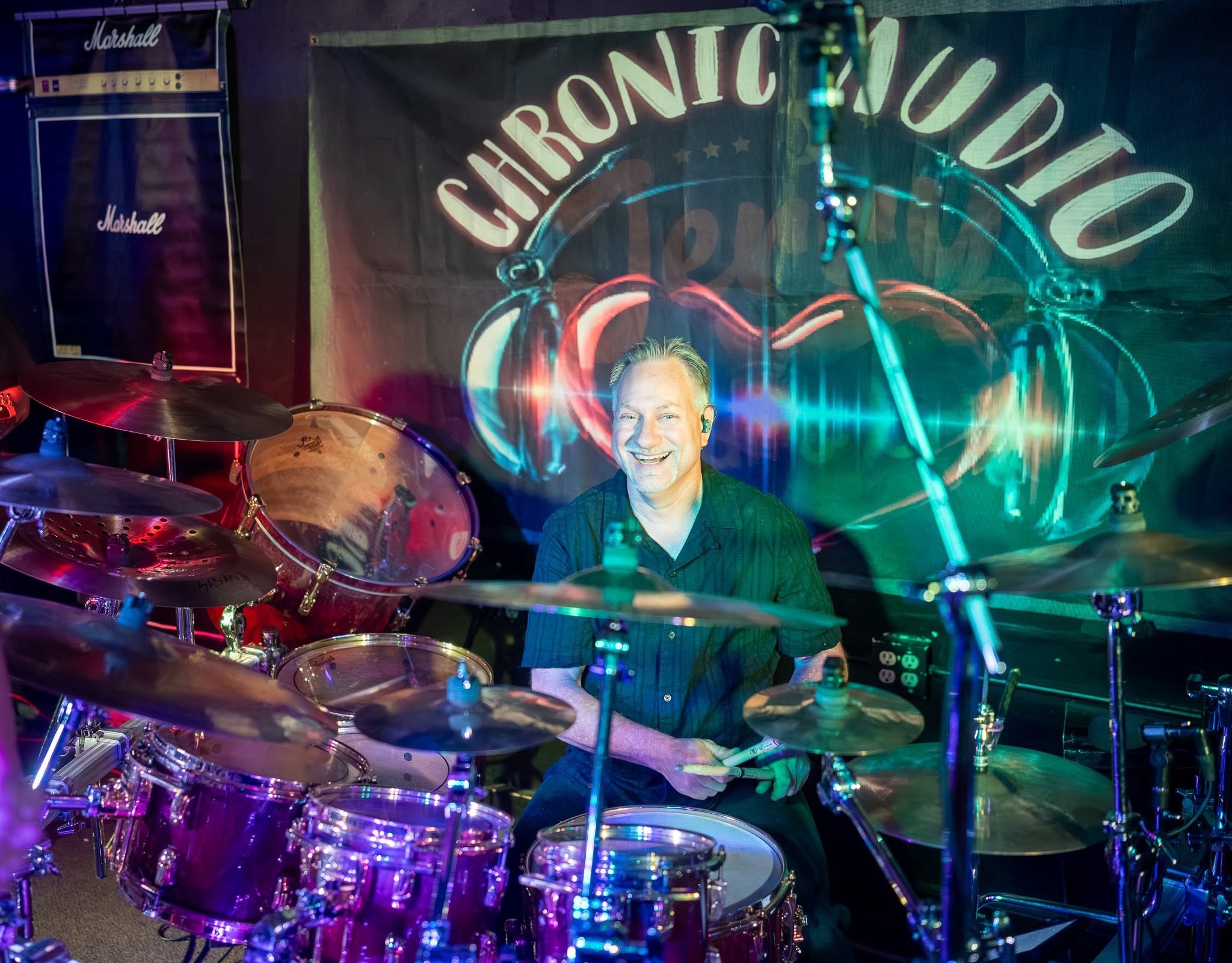 Paul smiling behind his drum kit